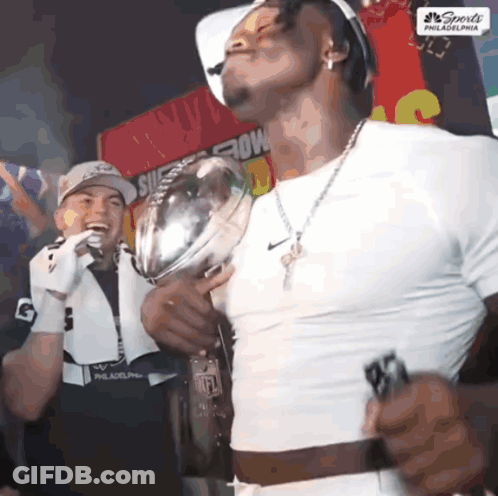 Man In White Shirt Holding Sports Trophy GIF