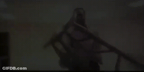 Man In White Shirt Holding Stool GIF