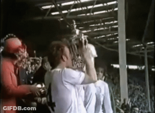 Man In White Shirt Holding Trophy GIF