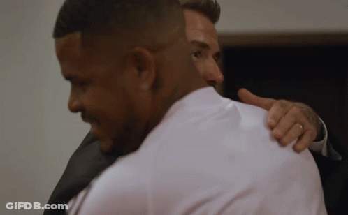 Man In White Shirt Hugging Man In Black Suit GIF