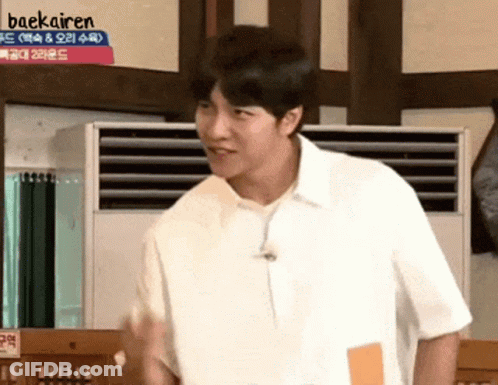 Man In White Shirt In Front Of Baekairen Sign GIF