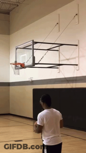 Man In White Shirt In Front Of Basketball Hoop GIF