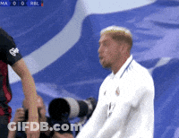 Man In White Shirt In Front Of Blue Background GIF