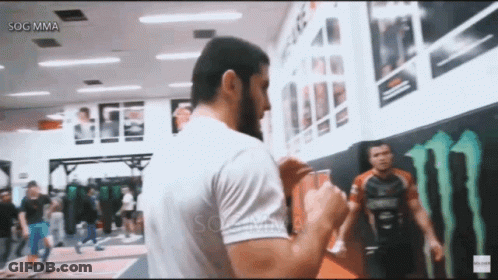 Man In White Shirt In Front Of Monster Energy Logo GIF