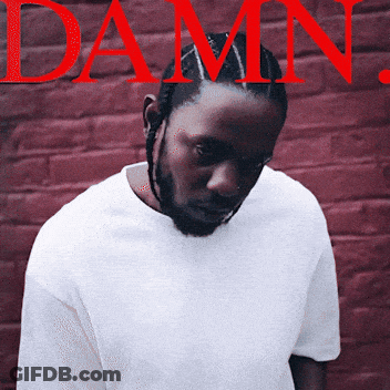 Man In White Shirt In Front Of Red Brick Wall Damn GIF