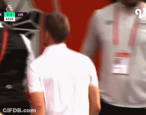 Man In White Shirt In Front Of Screen Saying Lee GIF