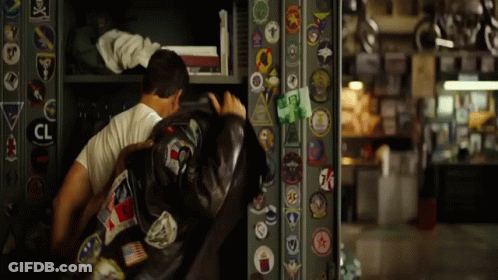 Man In White Shirt In Front Of Wall With CL Sticker GIF