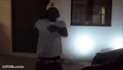 Man In White Shirt In Front Of White Building GIF