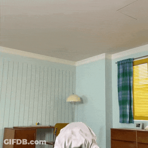 Man In White Shirt Jumping In Room GIF