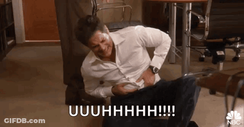 Man In White Shirt Laughing Holding Stomach GIF