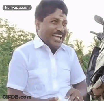 Man In White Shirt Laughing Next To Motorcycle GIF