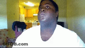 Man In White Shirt Looking At Camera In Living Room GIF