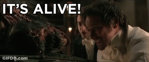 Man In White Shirt Looking At Monster Saying It's Alive GIF
