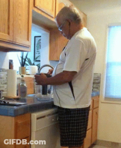 Man In White Shirt Looking At Phone GIF