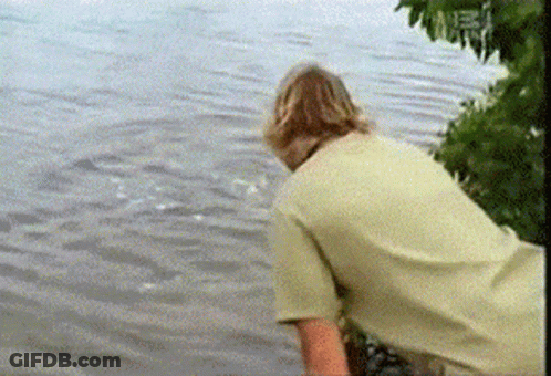 Man In White Shirt Looking Into Water GIF