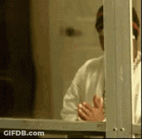 Man In White Shirt Looking Out Window GIF