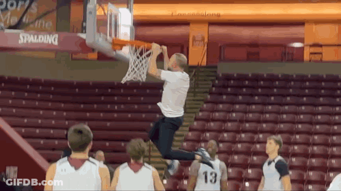 Man In White Shirt Number 13 Jumping Into Basketball Hoop GIF