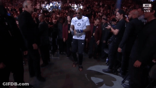 Man In White Shirt Number 18 Walking Through Crowd GIF