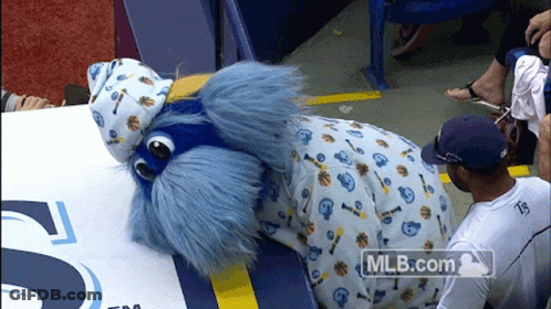 Man In White Shirt Number 35 Next To Mascot GIF