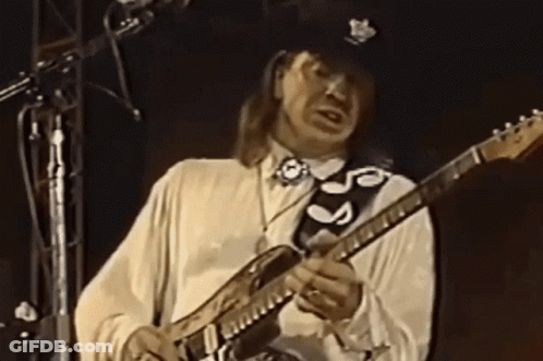 Man In White Shirt Playing Guitar With Black Strap S GIF