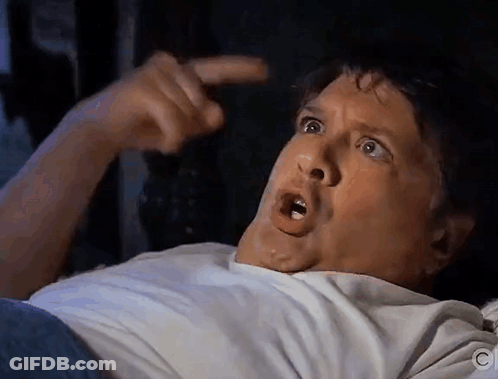 Man In White Shirt Pointing At Head GIF