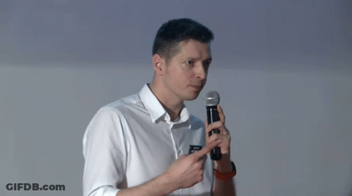 Man In White Shirt Pointing At Microphone GIF