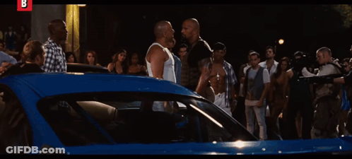 Man In White Shirt Pointing Gun At Camera Letter B GIF
