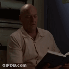 Man In White Shirt Reading Book With Eyes Closed GIF