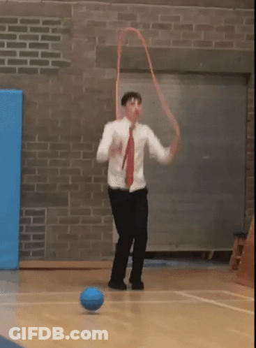 Man In White Shirt Red Tie Kicking Blue Ball GIF