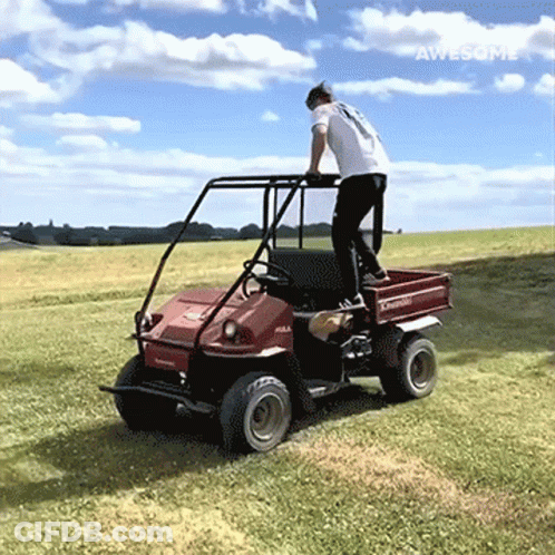 Man In White Shirt Riding Red Kawasaki Vehicle GIF