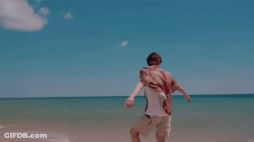 Man In White Shirt Running On Beach GIF