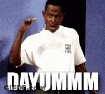 Man In White Shirt Saying Dayummm In Front Of Blue Wall GIF