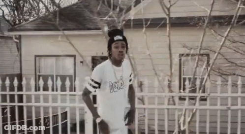Man In White Shirt Saying Delta In Front Of House GIF
