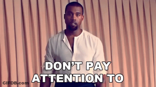 Man In White Shirt Saying Don't Pay Attention To In Front Of Pink Curtain GIF