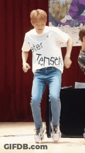 Man In White Shirt Saying Peter Tensen Dancing On Stage GIF