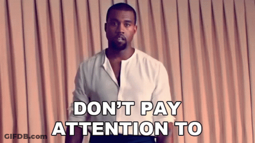 Man In White Shirt Says Don't Pay Attention In Front Of Pink Curtain GIF