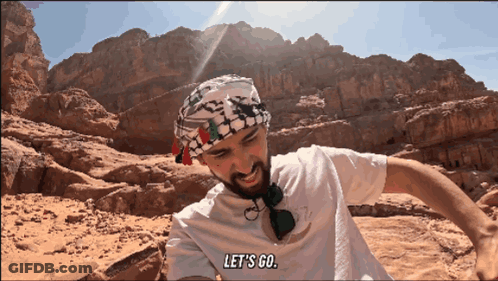 Man In White Shirt Says Let's Go In Desert GIF