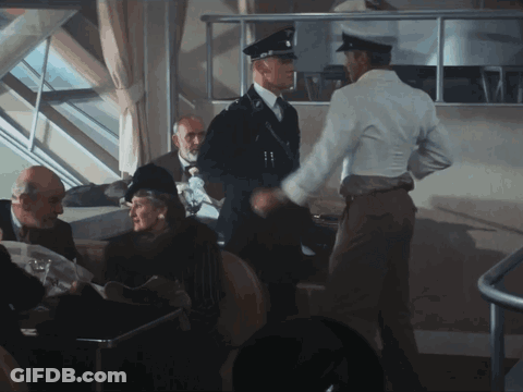 Man In White Shirt Shaking Hands With Man In Black Uniform GIF