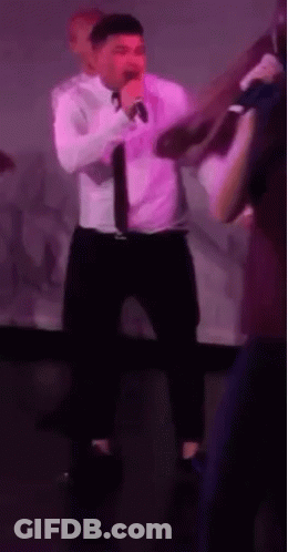 Man In White Shirt Singing Into Microphone GIF