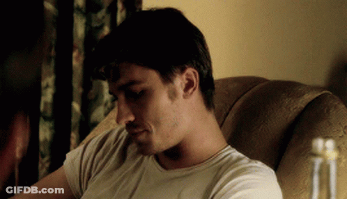 Man In White Shirt Sitting And Looking Down GIF