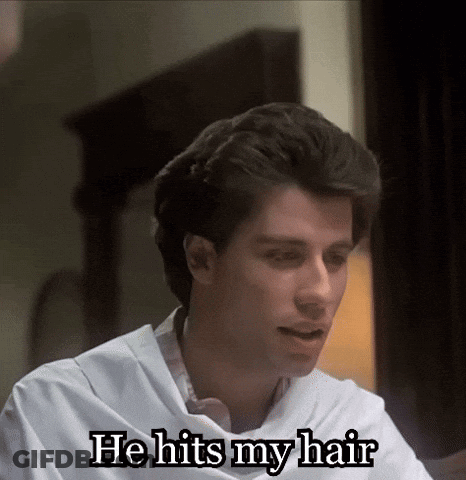Man In White Shirt Sitting At Table Says He Hits My Hair GIF