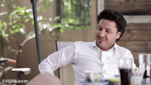 Man In White Shirt Sitting At Table With Coke GIF