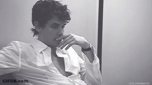 Man In White Shirt Sitting In Chair GIF