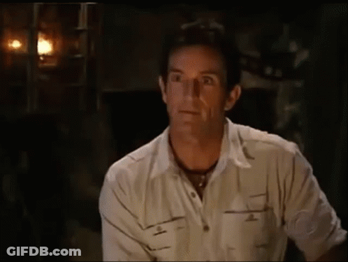 Man In White Shirt Sitting In Dark Room Eyes Closed GIF