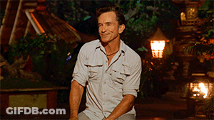 Man In White Shirt Sitting In Front Of Lamp GIF