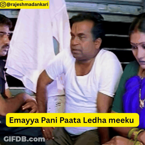 Man In White Shirt Sitting Next To Woman In Blue Dress GIF