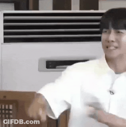 Man In White Shirt Smiling In Front Of Air Conditioner GIF