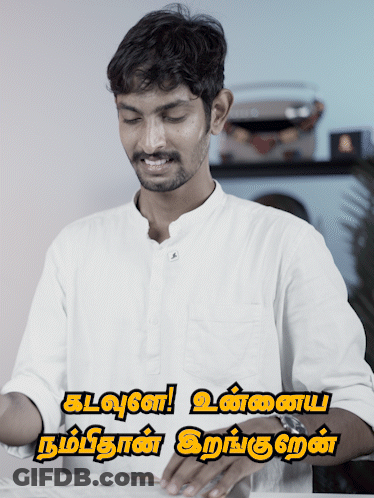 Man In White Shirt Smiling In Front Of Kalvan Sign GIF