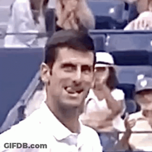 Man In White Shirt Smiling In Stadium GIF