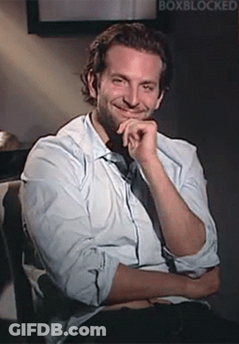Man In White Shirt Smiling With Hand On Chin GIF